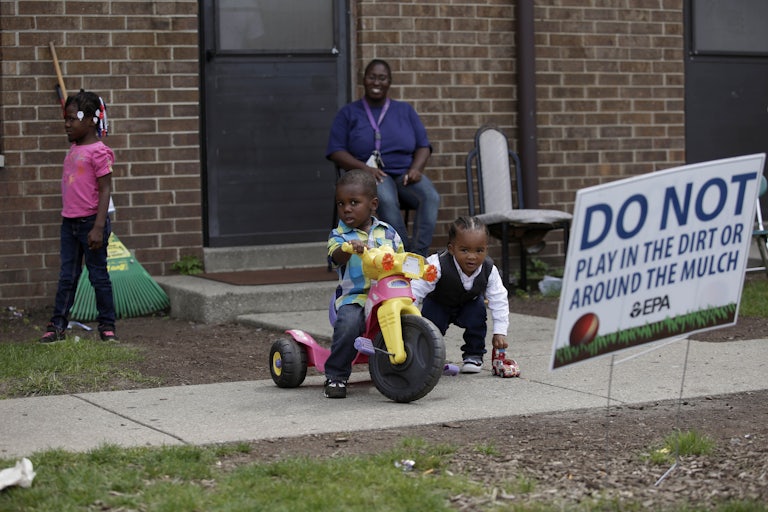 Children play at the West Calumet Housing Complex, which has been found to contain high levels of lead and arsenic.