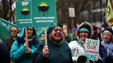 Demonstrators hold signs reading "BP: Profiting from Destruction."