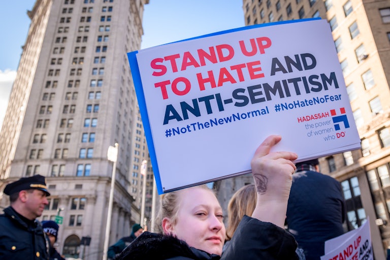 A protester holds up a sign against antisemitism at a rally in New York City's Foley Square.