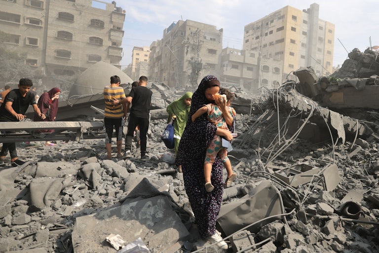 Palestinians evacuate following an Israeli airstrike on the Sousi mosque in Gaza City