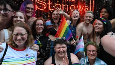 People pose in front of the Stonewall Inn in New York