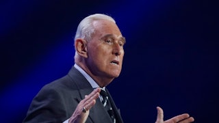 Roger Stone gestures while speaking