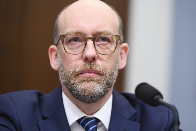 Former Donald Trump administration official Russell Vought sits in front of a microphone