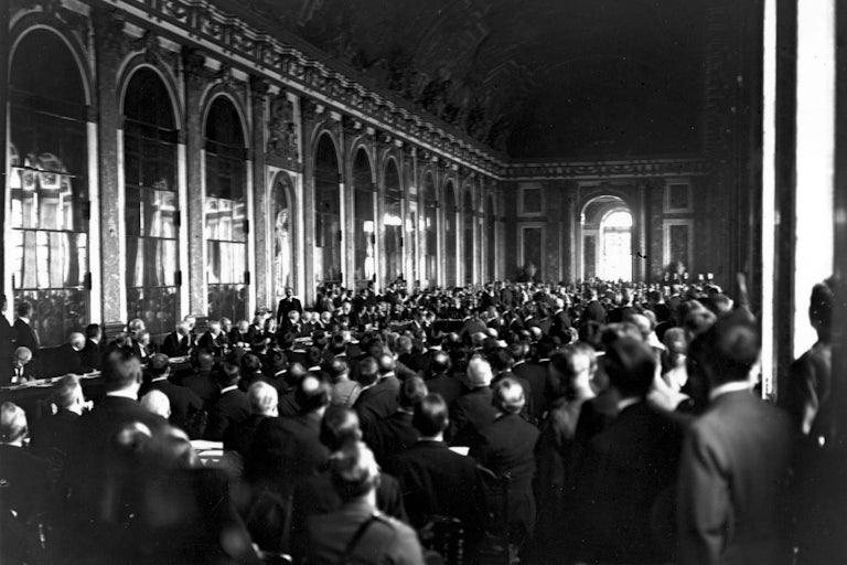 28th June 1919: Diplomats and delegates watching the signing of the Peace Treaty of Versailles in the Hall of Mirrors at Versailles in France.