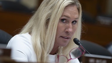 Marjorie Taylor Greene looks to the side