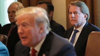 Former White House Counsel Don McGahn sits and watches President Donald Trump.