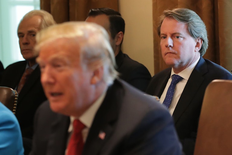 Former White House Counsel Don McGahn sits and watches President Donald Trump.