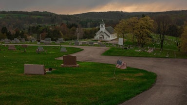 A church in Grant Township sits surrounded by rolling hills and a cemetery.