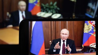A screen displaying Russian President Vladimir Putin speaking during a televised address to the Russian people.