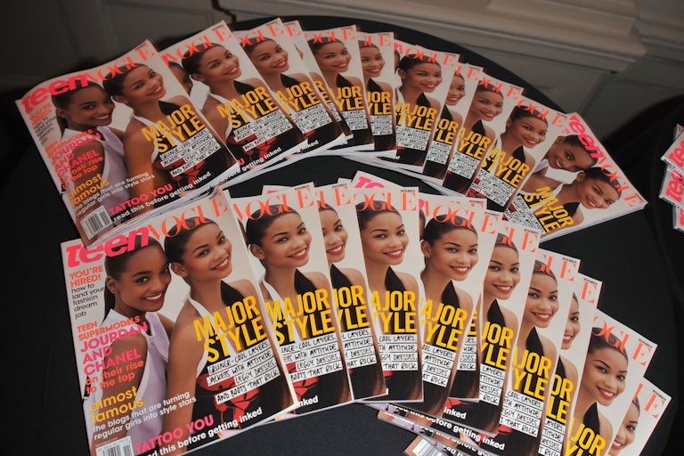 Copies of Teen Vogue magazine are displayed on a table