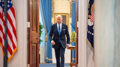 Joe Biden exits a room in the White House