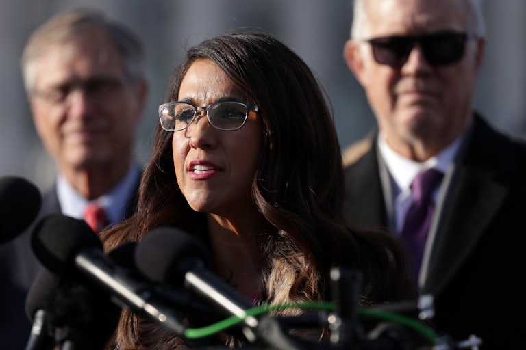 Lauren Boebert speaks at a podium with several mics