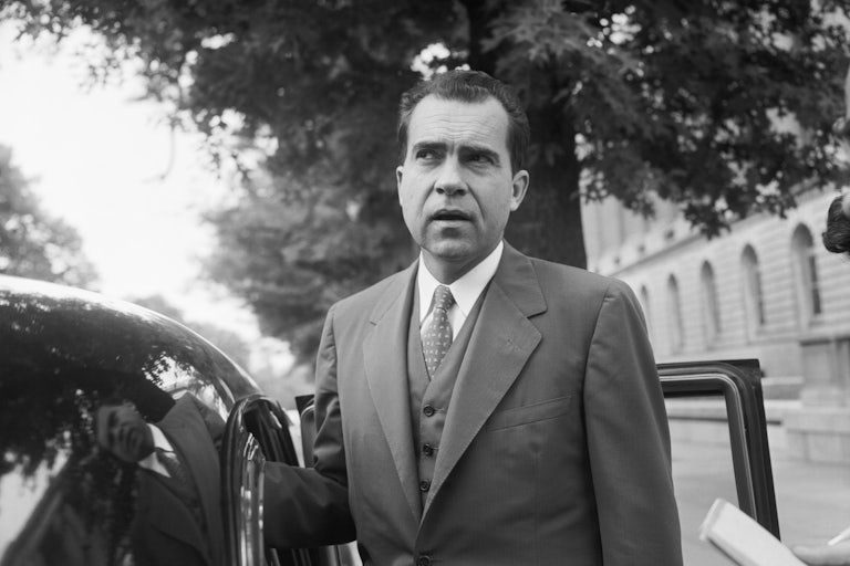 Vice President Richard Nixon speaks with members of the media before leaving his Capitol Hill office in 1956.