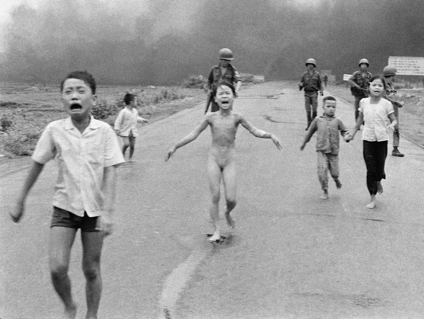 Nine-year-old Kim Phúc running naked and screaming after a napalm attack, on a road in Trang Bang, Vietnam, 1972.