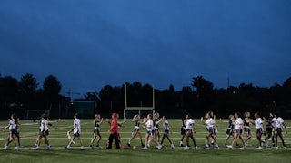 Girls high-five after a sports match