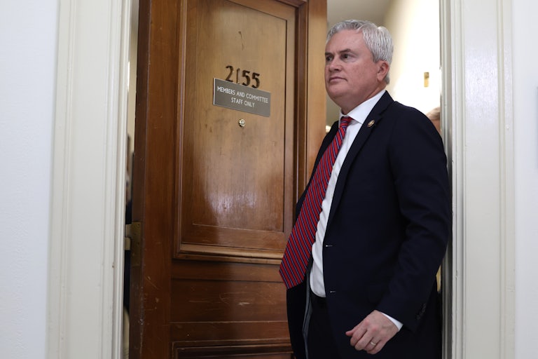 House Oversight Chair James Comer leaves a room. The door behind him says "2155 Members and Committee Staff Only."
