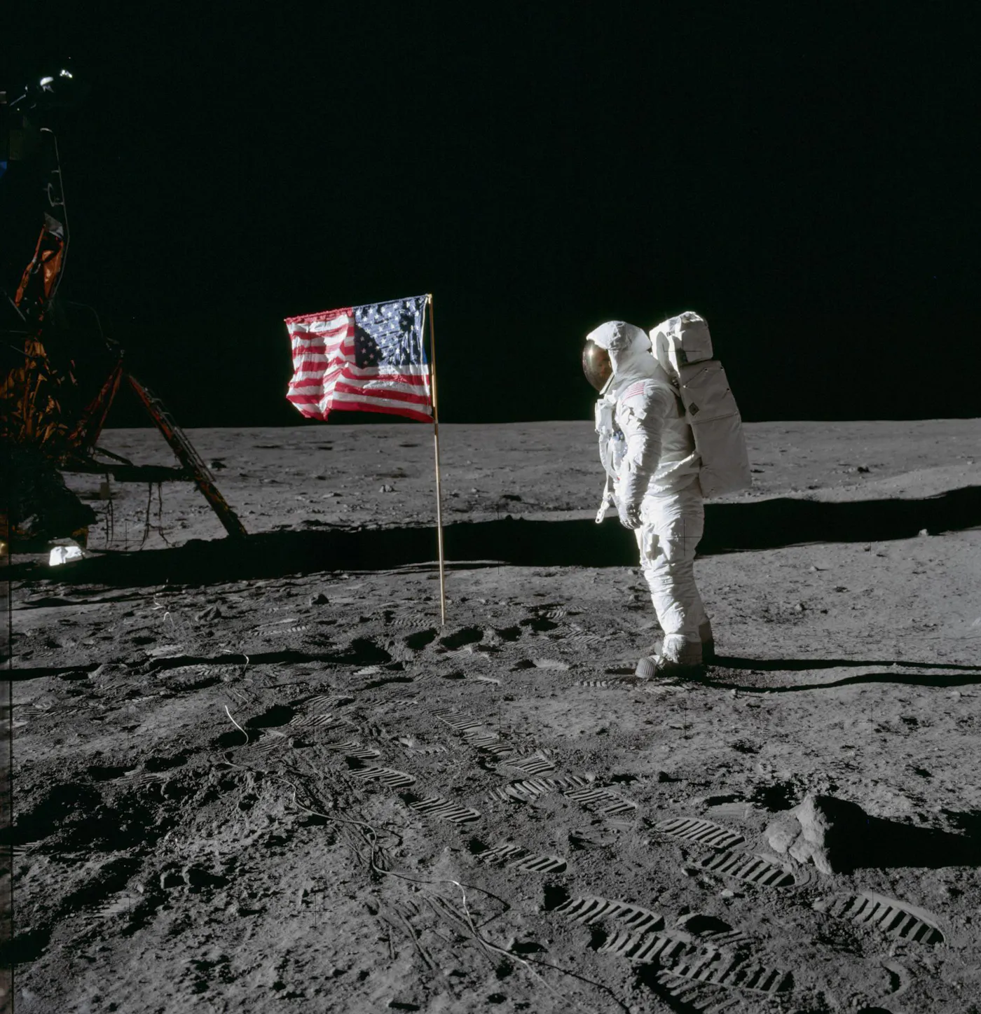 Buzz Aldrin stands on the moon beside a American flag during the Apollo moon landing, July 20, 1969.