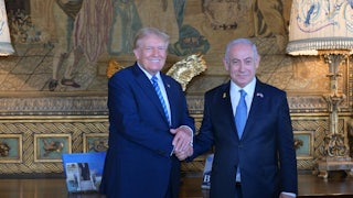 Donald Trump shakes Benjamin Netanyahu's hands while the two smile for the camera