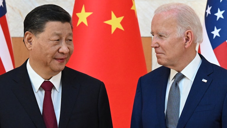 Xi Jinping and Joe Biden look at one another.