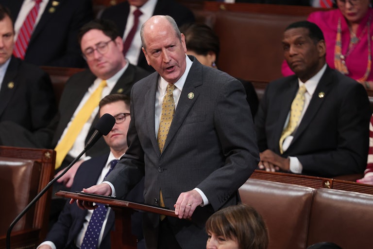 Representative Dan Bishop speaks at a podium on the House floor