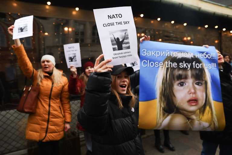 Ukrainian citizens and supporters demonstrate outside the U.S. Consulate General in Krakow, Poland.