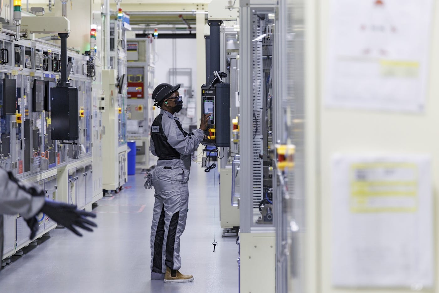 A worker operates a control interface inside the battery-cell clean room at the Ultium Cells plant inside a General Motors factory in Spring Hill, Tennessee.