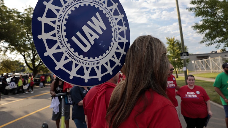 A United Auto Workers supporter holds a sign during a Labor Day parade in Detroit, Michigan.