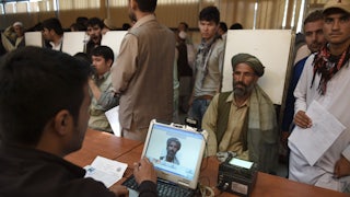 An Afghan man has his photograph taken for facial biometric information at the passport office in Kabul.