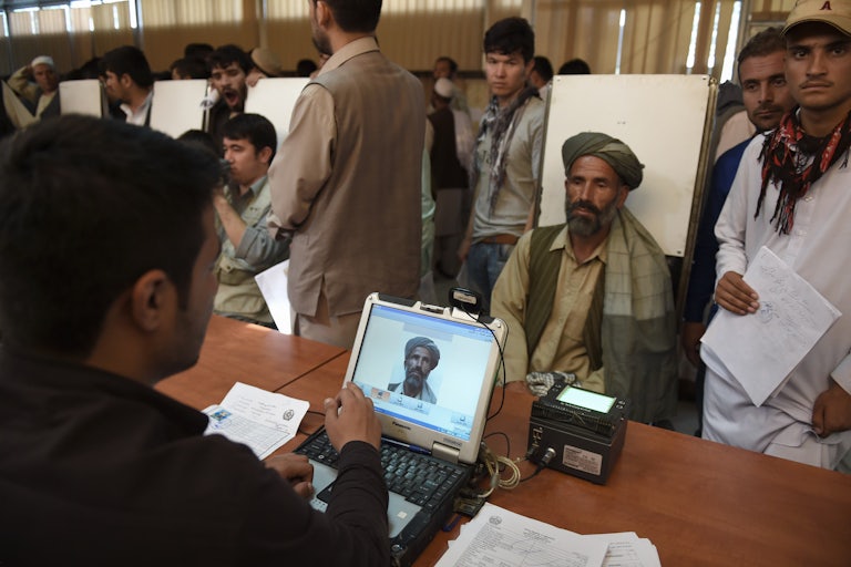 An Afghan man has his photograph taken for facial biometric information at the passport office in Kabul.