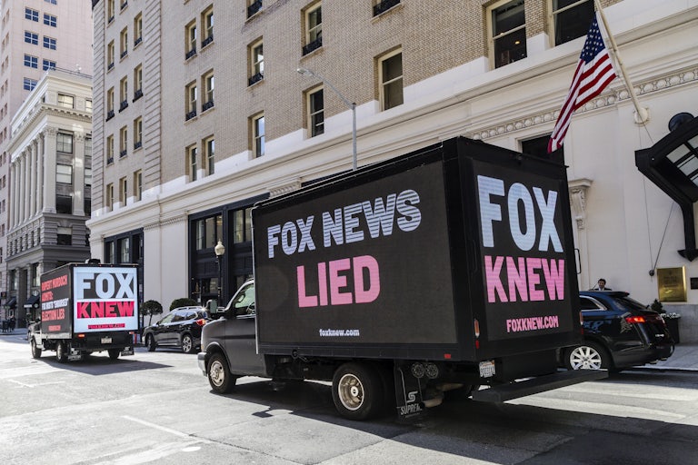Truck billboards call out Fox News' election denial scheme.