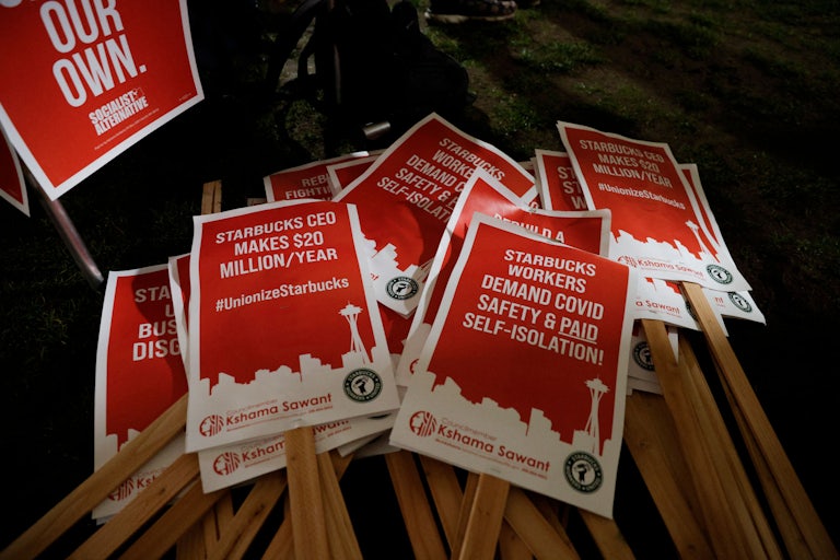 Picket signs are pictured at a rally in support of workers of two Seattle Starbucks locations that announced plans to unionize.