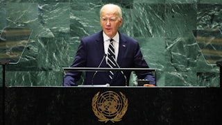 President Joe Biden stands at a lectern bearing the United Nations logo.