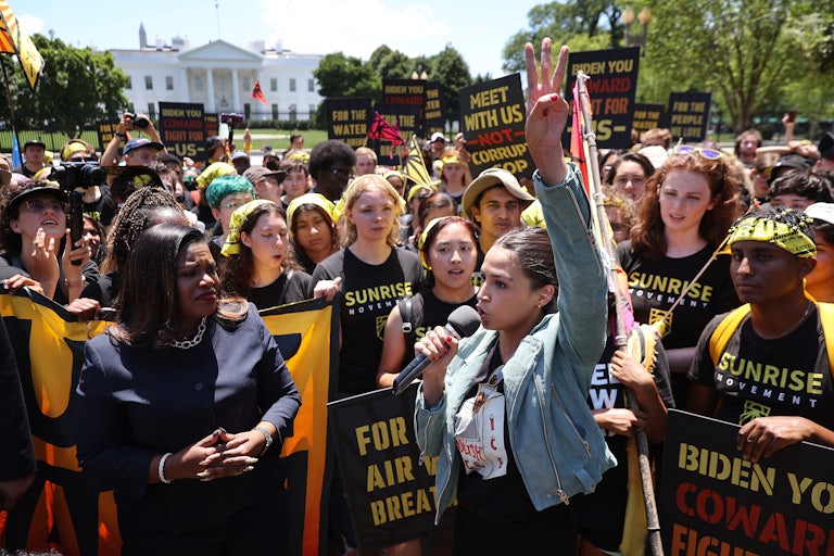 Cori Bush and Alexandria Ocasio-Cortez stand with protesters in front of the White House.