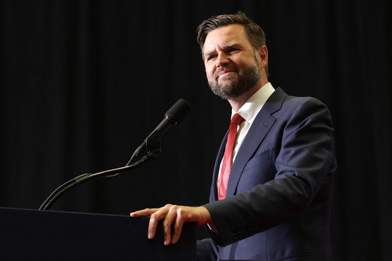 J.D. Vance smiles at a podium