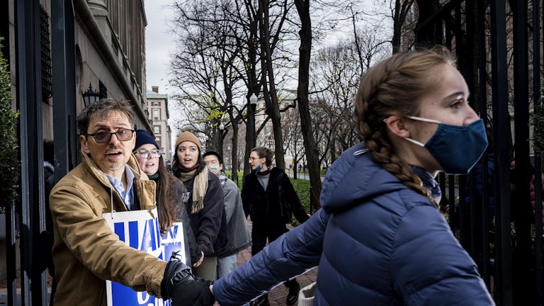 striking student workers hold hands on the picket line at Columbia University