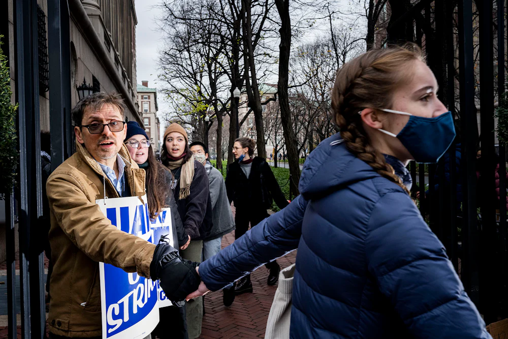 striking student workers hold hands on the picket line at Columbia University
