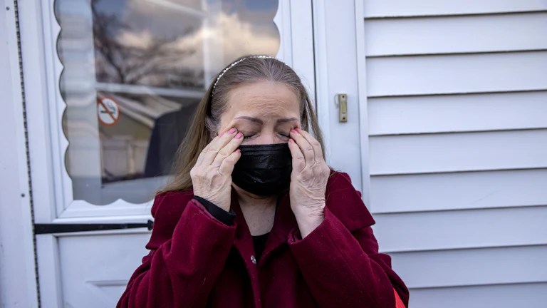 Maria Romero, a Covid "long hauler," weeps