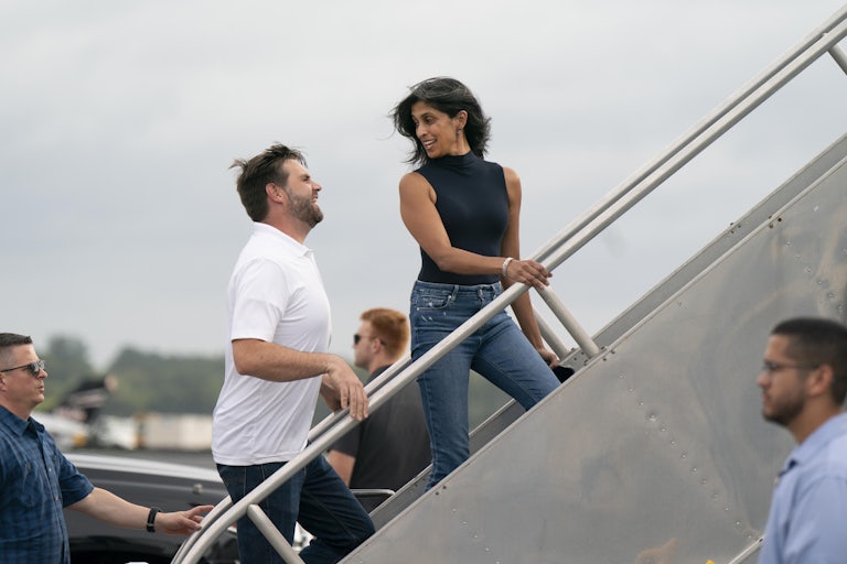 J.D. Vance and his wife Usha Vance look at each other while boarding a plane