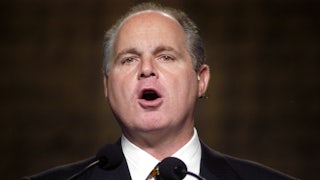 Rush Limbaugh in 2003 speaking in front of two microphones