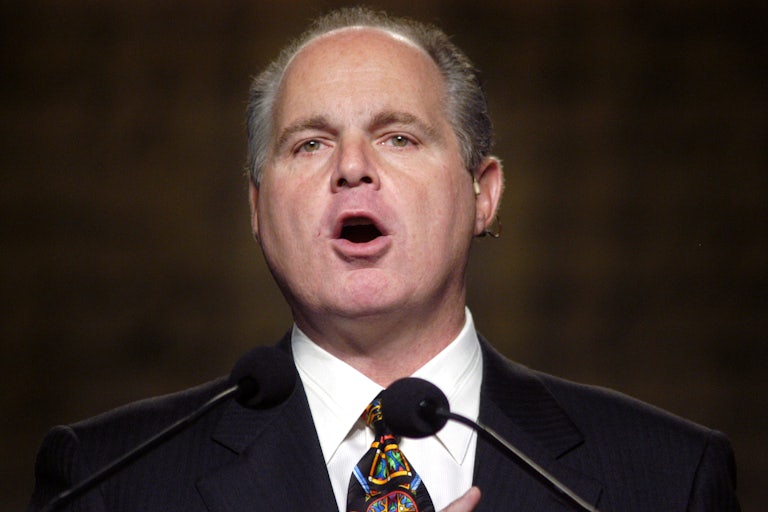 Rush Limbaugh in 2003 speaking in front of two microphones