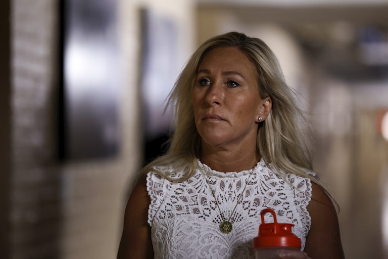 Marjorie Taylor Greene walks down a hallway
