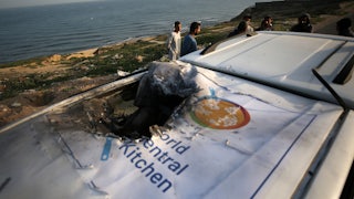 Palestinians check a World Central Kitchen vehicle struck by Israeli drones