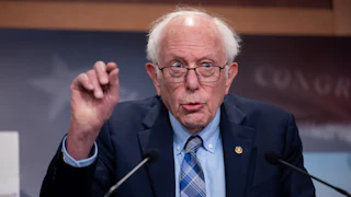 Bernie Sanders gestures while speaking to reporters
