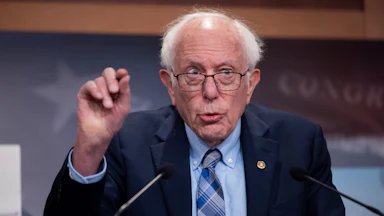Bernie Sanders gestures while speaking to reporters