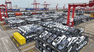 Cars are seen stacked in racks at a container terminal.