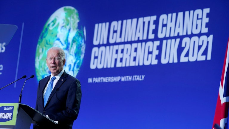 President Joe Biden delivers a speech on stage during a meeting at the COP26 UN Climate Change Conference in Glasgow, Scotland.