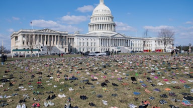 The lawn outside the US Capitol is covered with pairs of empty shoes to memorialize the children killed by gun violence since the Sandy Hook school shooting.