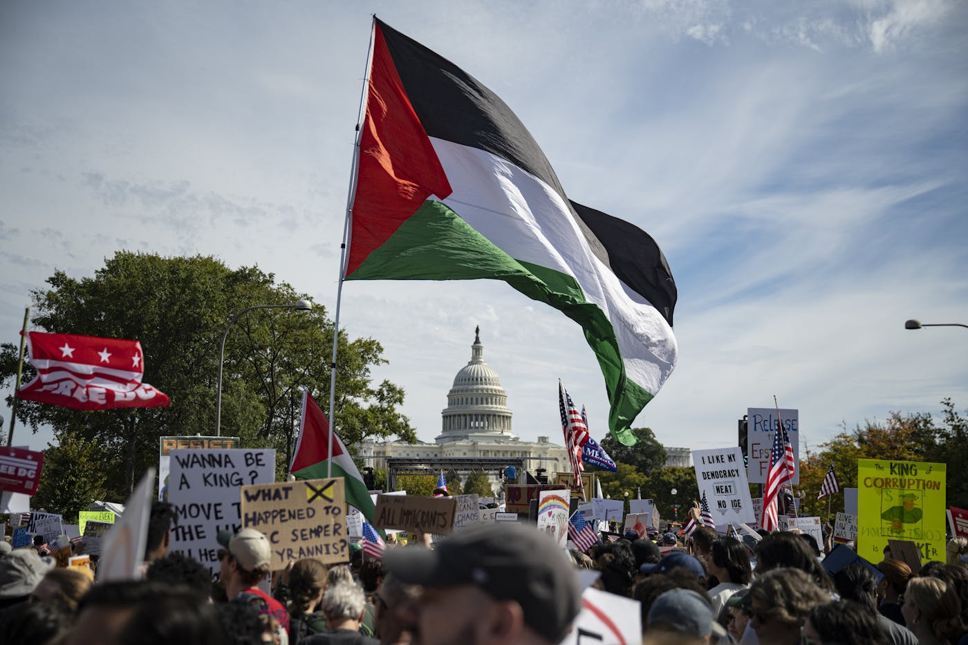 A large Palestinian flag waves in the air above protesters at the No Kings protest near the Capitol in Washington, D.C.