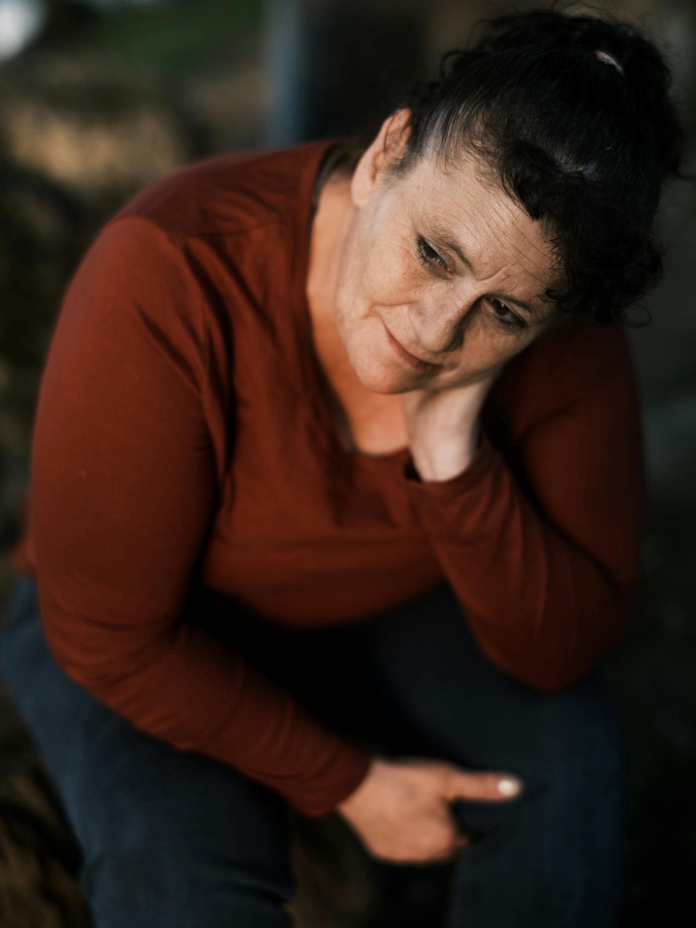 Helen Cruz, who works as the caretaker of a local church, sits in Riverside Park, where she used to live.