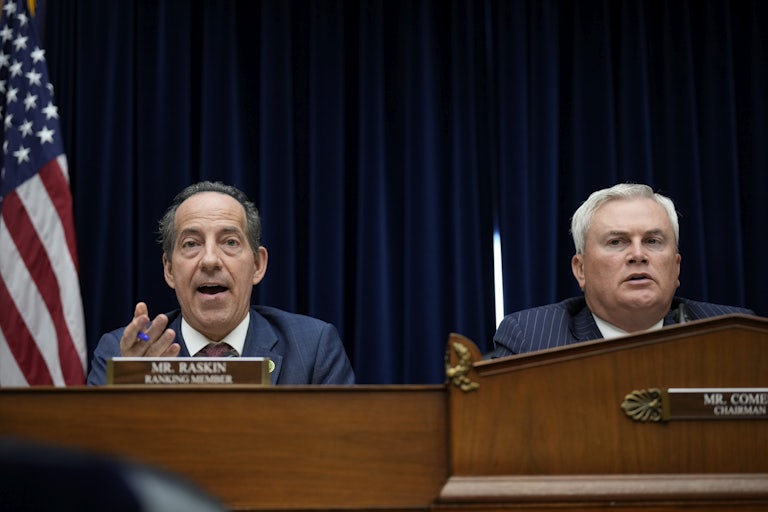 Jamie Raskin and James Comer sit next to each other